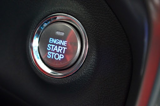 A push-to-start button on a vehicle dashboard.