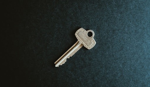 A single key on a gray background. 