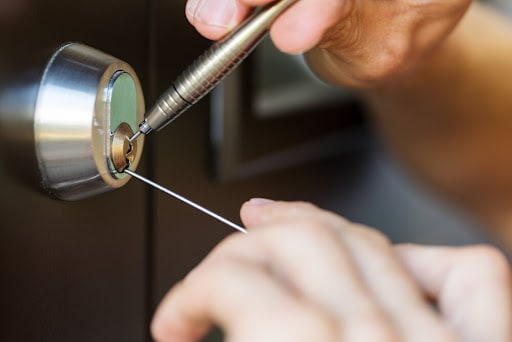 A locksmith opening the lock on a home safe.