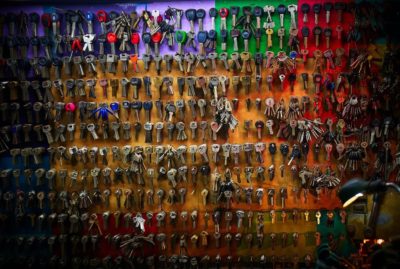 Wall full of keys hanging on hooks.