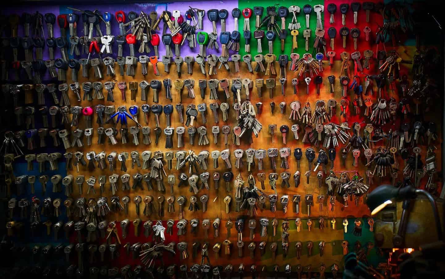 Wall full of keys hanging on hooks.