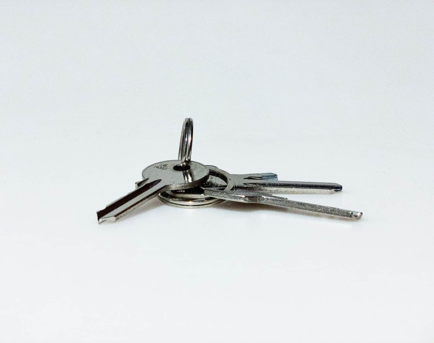 Three keys on a keyring on a white background.