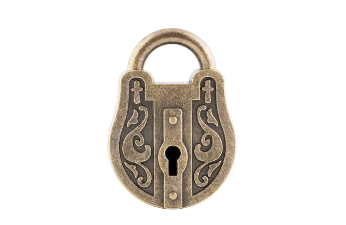 A brass padlock with swirl motifs.