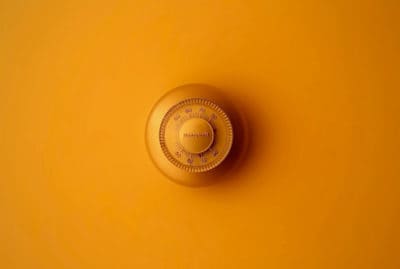 Orange combination lock on an orange surface.