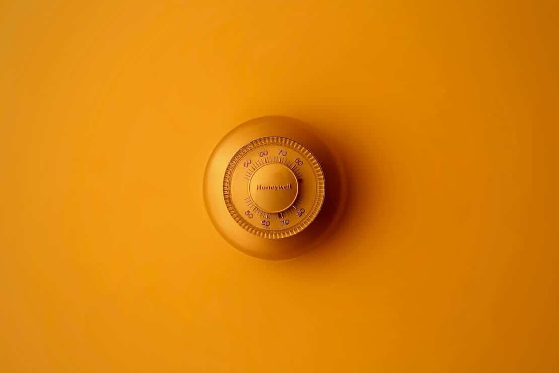 Orange combination lock on an orange surface.