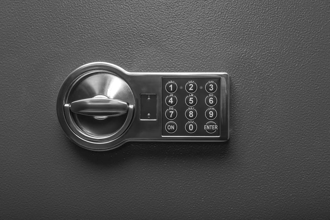 Code lock on the safe door. A safe with a keypad and bolt lock.