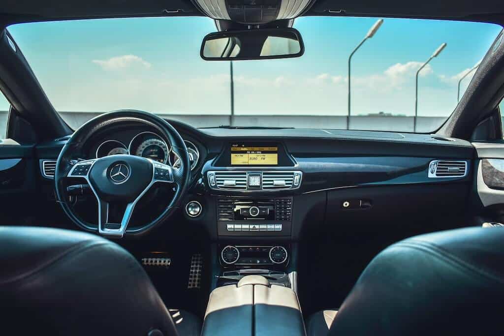 The inside of a car showing the front seat from the back.