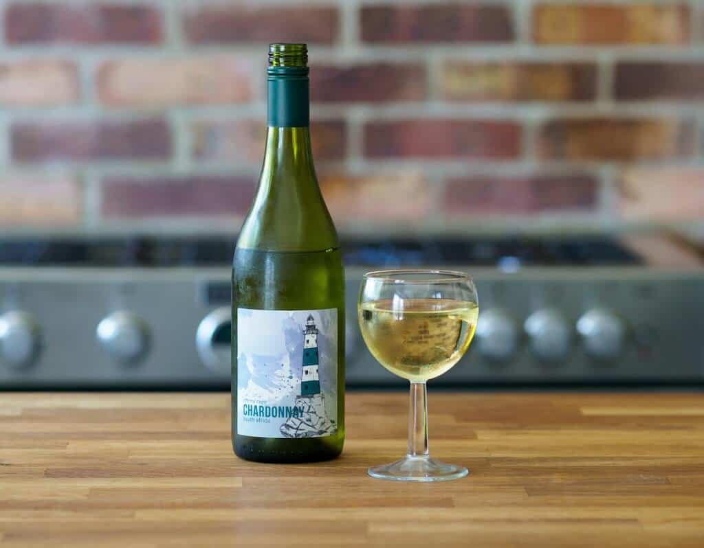 brett-jordan-dI5M7Dwl_5I-unsplash (1) (1) Glass of white wine with the bottle next to it.