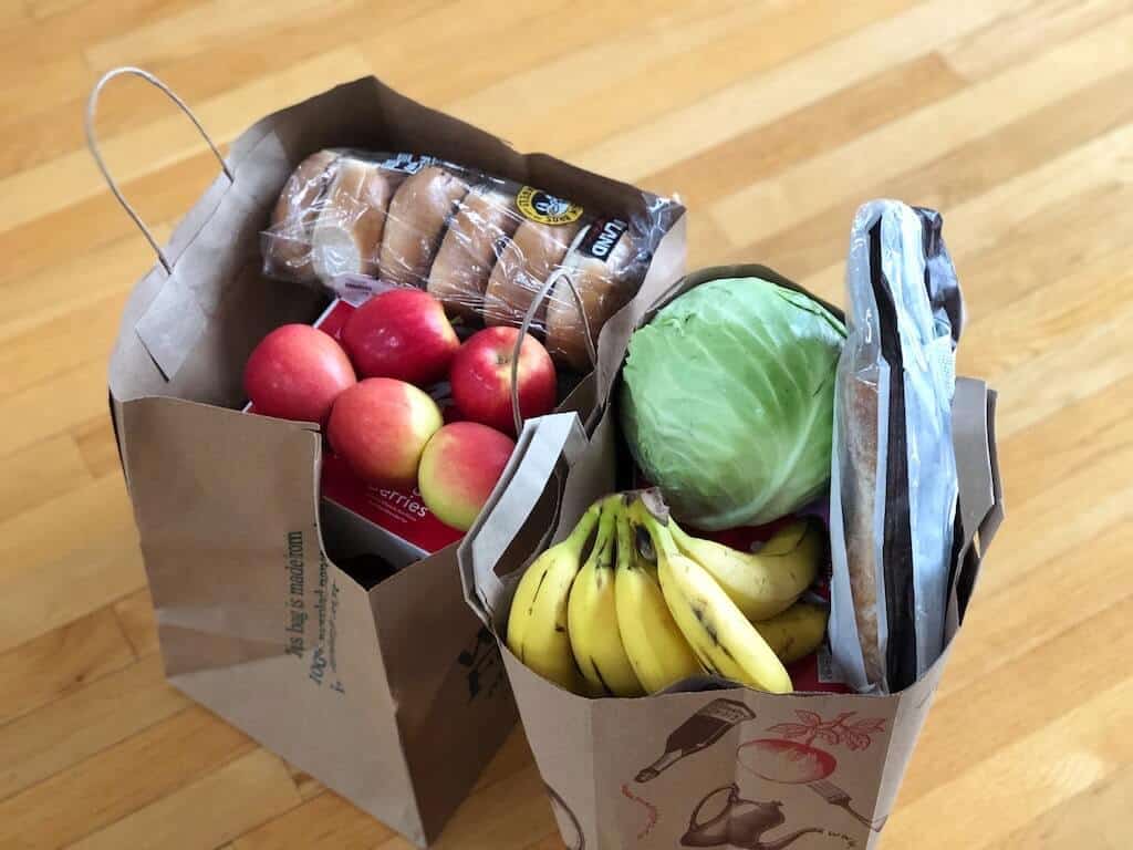 Two full paper bags of groceries.