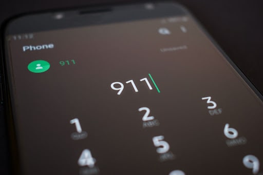 A photo of a phone screen on the dial page with “911” typed in, ready to dial.