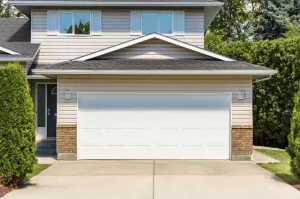 A outdoor photo of a home with a garage door.