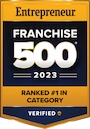 Two-toned black badge with yellow text reading 'Entrepreneur; Franchise 500; Ranked number 1 in category; 2023'.