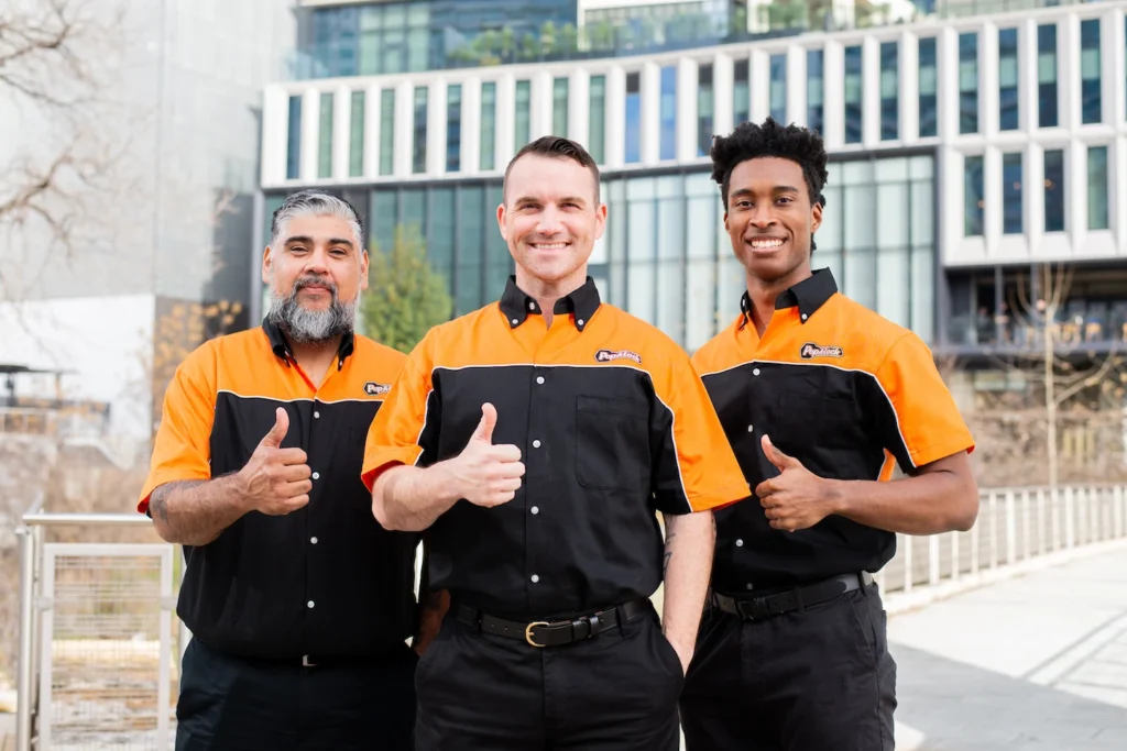 Three commercial locksmiths from Pop-A-Lock Oahu standing in front of an office building.