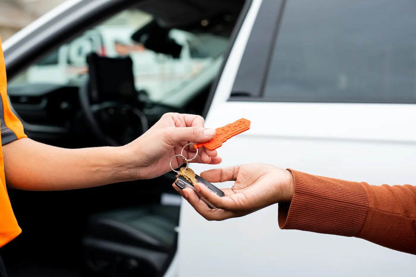 Commercial locksmith in Metairie handing a set of master keys to a commercial auto fleet owner.