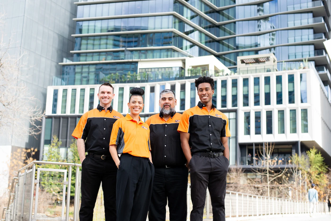 Four Pop-A-Lock Metairie technicians standing in front of a commercial office space.