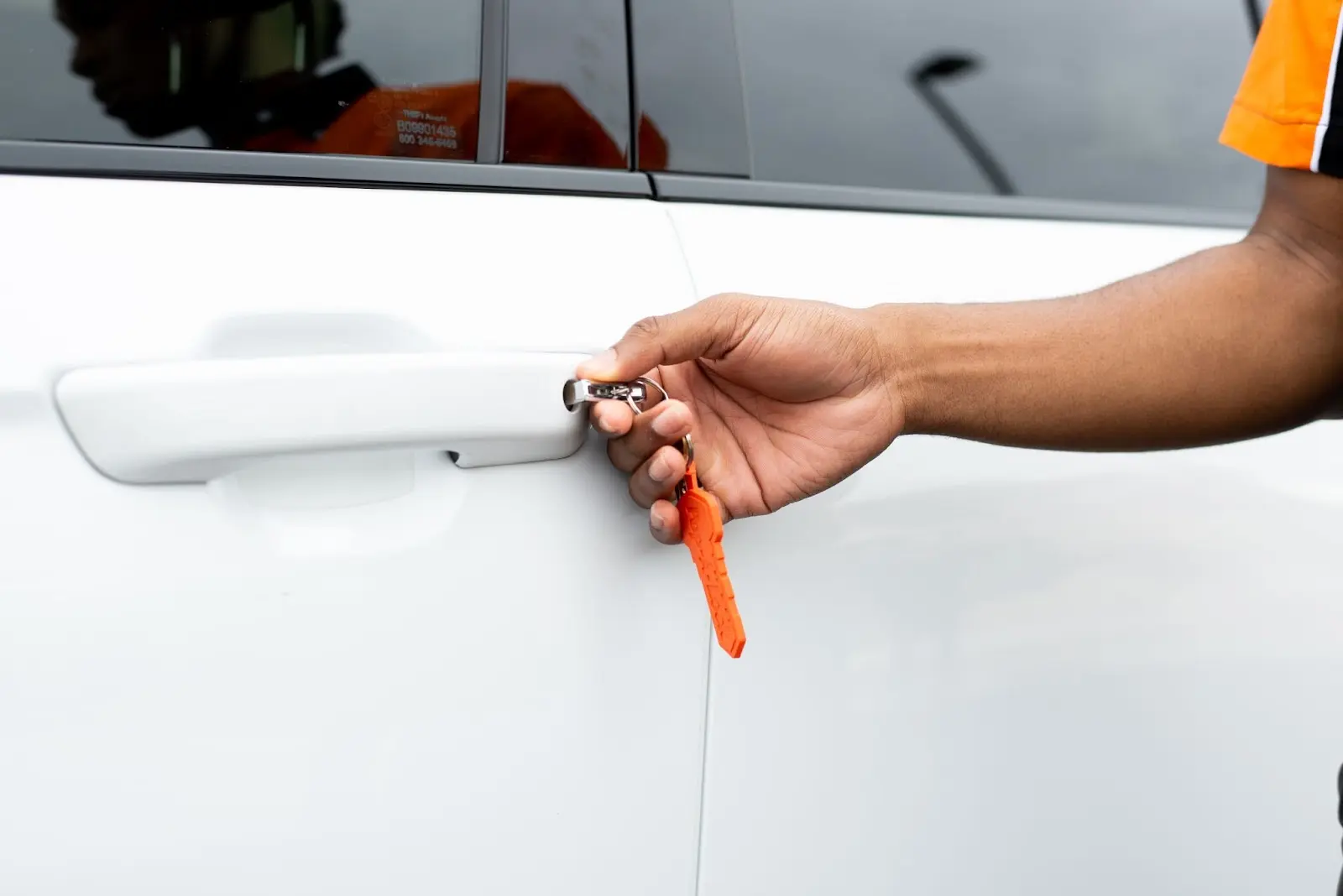 Locksmith in Manhattan unlocking a car door.