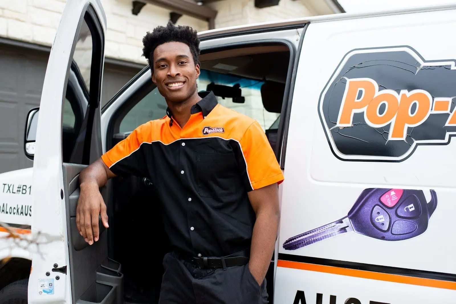 Car key replacement technician in Tulsa standing outside of Pop-A-Lock van.