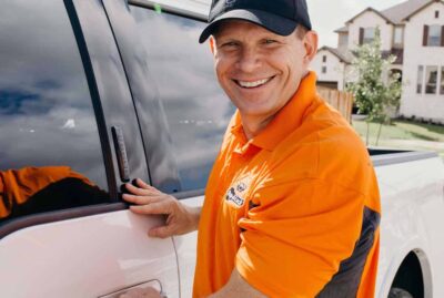 Key fob locked in a car, with a professional from Pop-A-Lock in Houston assisting to unlock the vehicle.