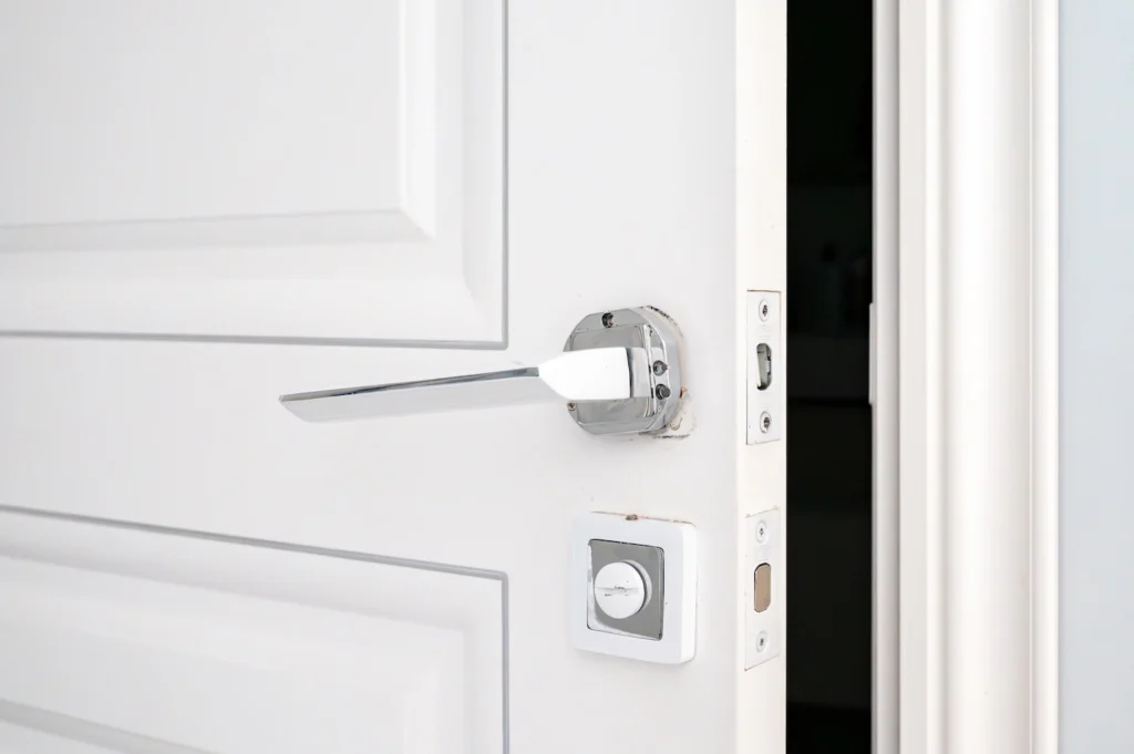 White door in home interior is ajar.