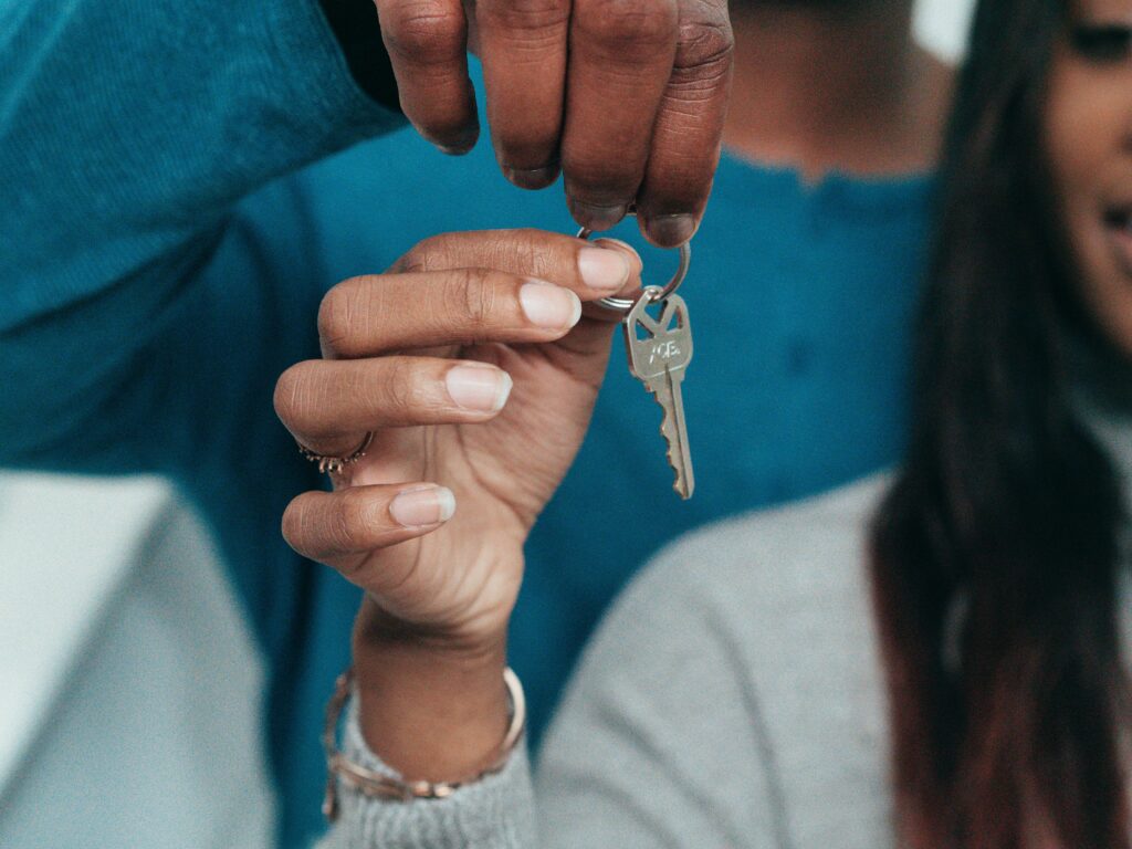 Lafayette woman holding a new key provided by a local, reliable locksmith in Louisiana.