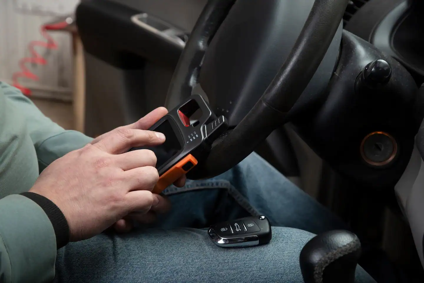 Locksmith programming and pairing a car key replacement with a vehicle.
