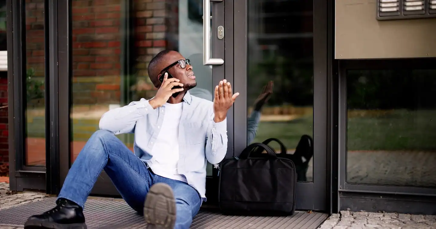 Man calling his local locksmith after he is locked out of his home.
